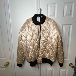 COLLUSION Unisex quilted satin bomber in gold.